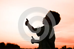 Happy children playing on nature summer silhouette