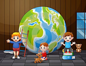 Happy children playing near the big globe