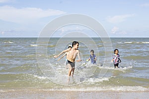 Happy Children playing in the Ocean