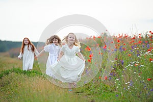 Happy children playing outdoors. Three girls running.