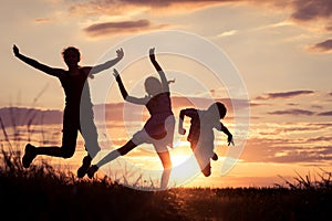 Happy children playing in the park at the sunset time