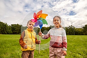 happy children playing with pinwheel at park