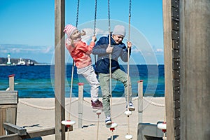 Happy children playing at playground on a beach