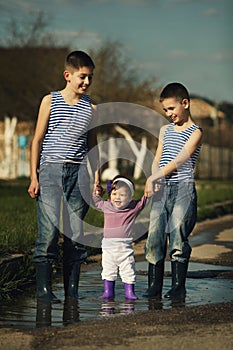 Happy children playing in the puddle