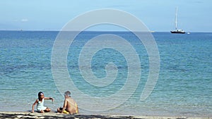 Happy children playing sand on the beach