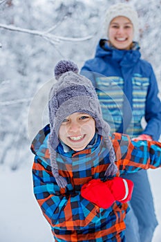 Happy children playing on snowy winter day.