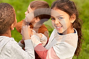 happy children playing and stacking hands at park