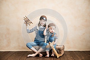 Happy children playing with toy airplane