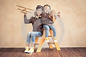 Happy children playing with toy airplane