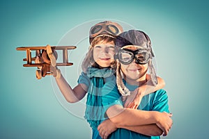 Happy children playing with toy airplane