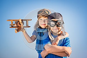 Happy children playing with toy airplane