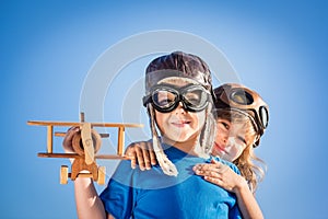 Happy children playing with toy airplane