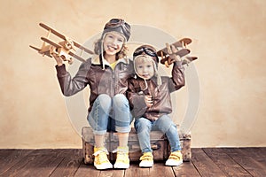 Happy children playing with toy airplane