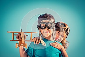 Happy children playing with toy airplane