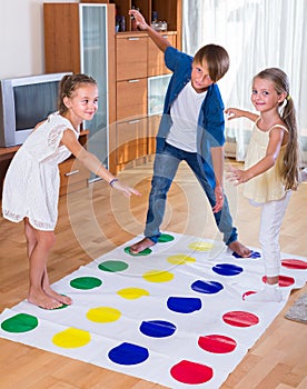 Happy children playing at twister