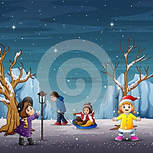 Happy children playing in winter landscape