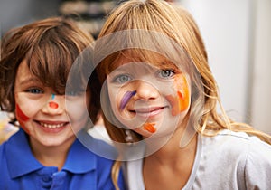 Happy children, portrait and face paint with color for artwork, craft or creativity at elementary school. Little girl