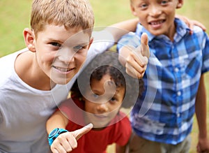 Happy children, portrait and thumbs up in nature for teamwork, winning or good job together at park. Group of casual