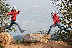 Happy children, running and jumping and playing in autumn colorful park