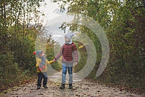 Happy children, running and jumping and playing in autumn colorful park