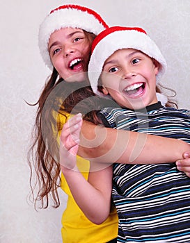 Happy children with Santa Claus red hats