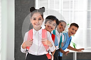 Happy children in school uniform with backpacks