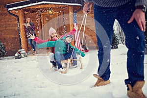 Happy children sledding at winter time