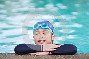 Happy children Smiling cute little girl in sunglasses in swimming pool