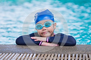Happy children Smiling cute little girl in sunglasses in swimming pool