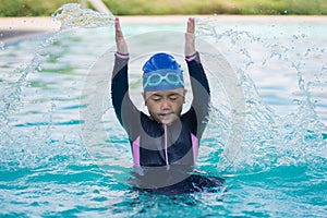 Happy children Smiling cute little girl in sunglasses in swimming pool