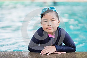 Happy children Smiling cute little girl in sunglasses in swimming pool