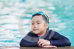 Happy children Smiling cute little girl in sunglasses in swimming pool