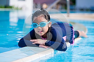 Happy children Smiling cute little girl in sunglasses in swimming pool