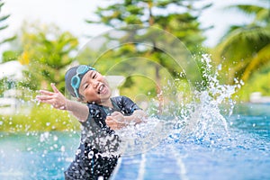 Happy children Smiling cute little girl in sunglasses in swimming pool