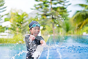 Happy children Smiling cute little girl in sunglasses in swimming pool