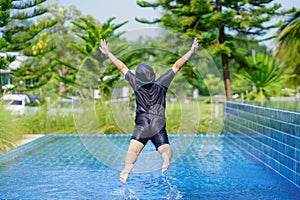 Happy children Smiling cute little girl in sunglasses in swimming pool