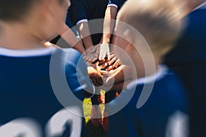 Happy Children Sports Team Stacking Hands. Kids Having Fun During Outdoor Physical Education Practice