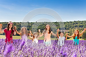 Happy children standing together in lavender field