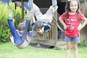 Happy children swinging