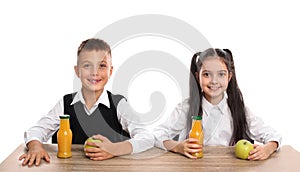 Happy children at  table with healthy food on white background