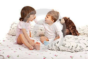 Happy children talking in bed