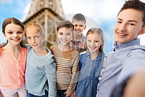 Happy children talking selfie over eiffel tower