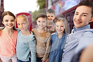 Happy children talking selfie over london city