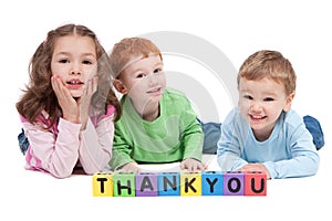 Happy children with thankyou kids letter blocks