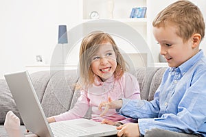 Happy children using laptop