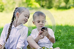 Happy children using tablet PC and smartphone