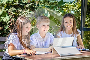 Happy children watching online education video classes at home