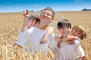 Happy children in wheat field