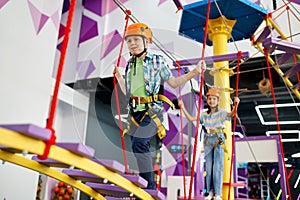 Happy children on zip line in entertainment center