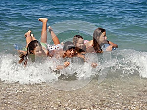 Happy childrens enjoy on waves